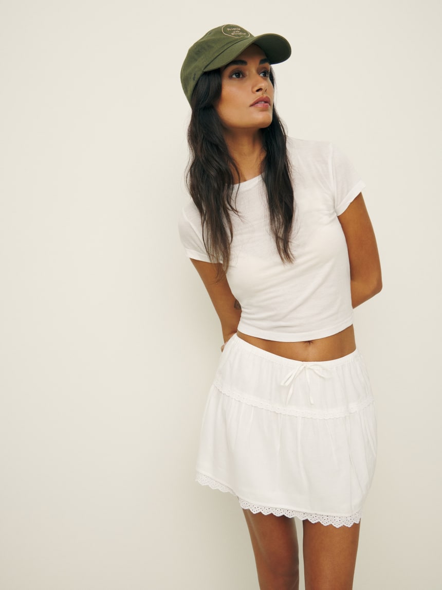 Reformation white tavia mini skirt with broderie anglaise trim. 