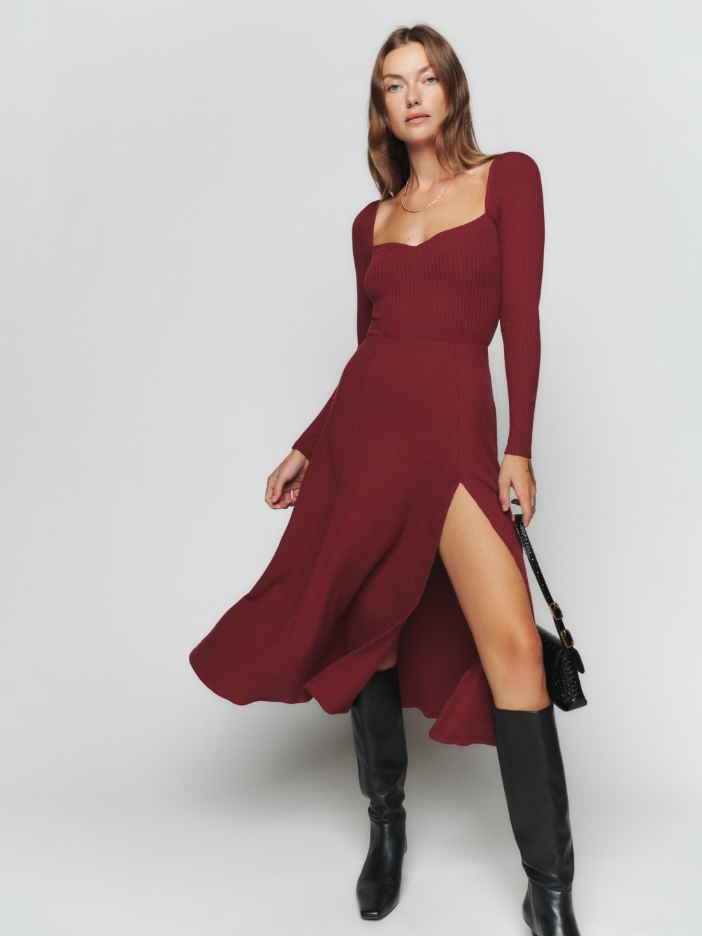 Reformation burgundy Banks knit dress has a Sweetheart neckline, fitted waist, long sleeves, and side slit. It comes in a Cotton Sweater Rib is a medium weight. 