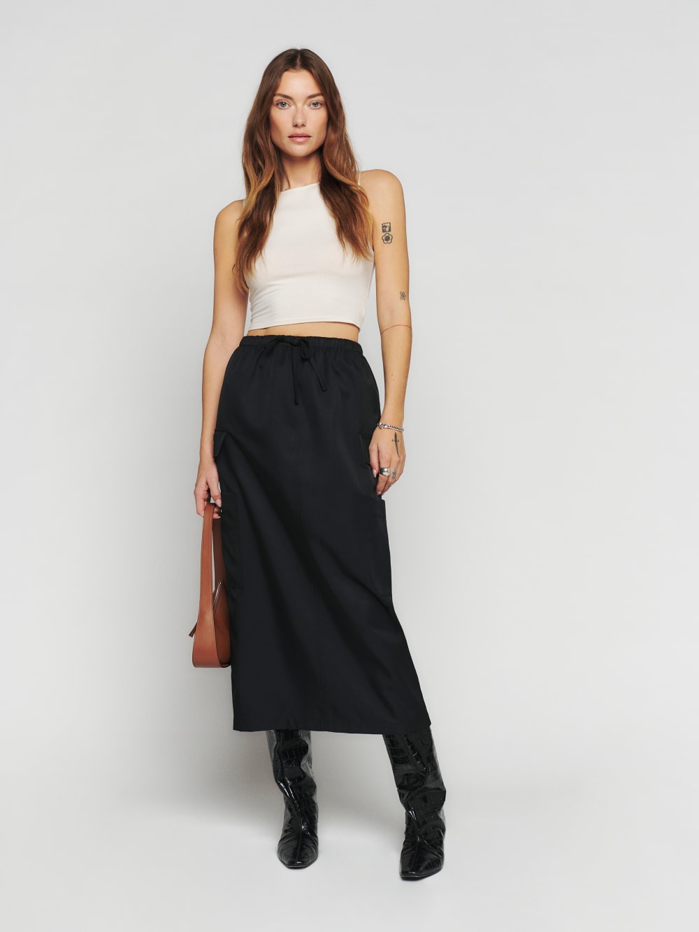 Reformation Ethan cargo midi skirt in black has Cargo pockets, a Drawstring at the waist and a Relaxed fit with cargo pockets on the side. 