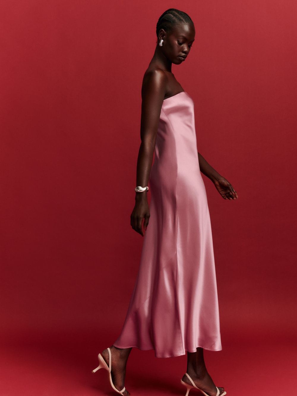 2024 wedding guest outfits - The reformation pink silk Joana Bandeau midi dress is slim fitting and minimalist in silhouette. 