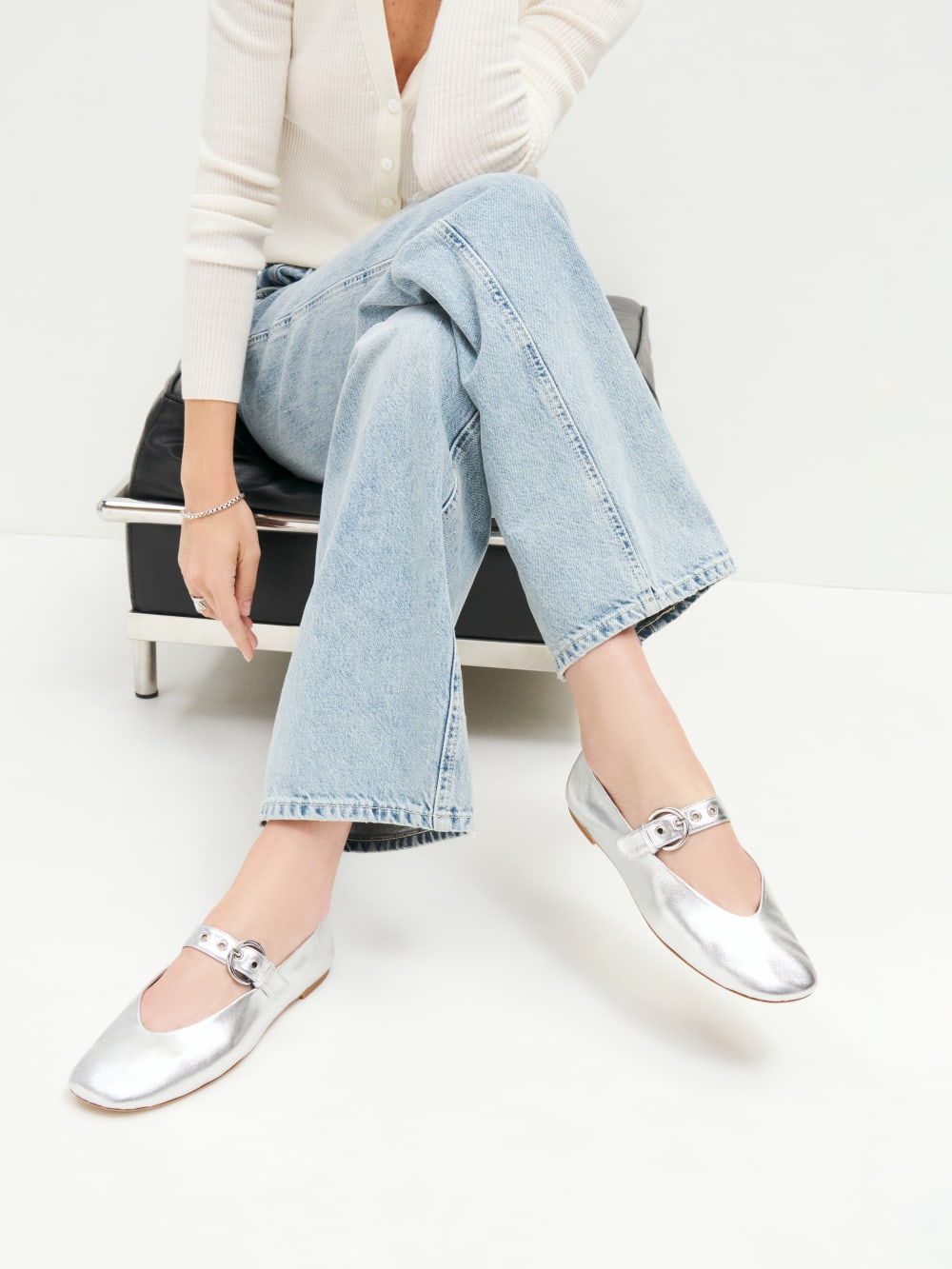 Reformation silver Bethany ballet flat  with a strap across the front and adjustable buckle. 