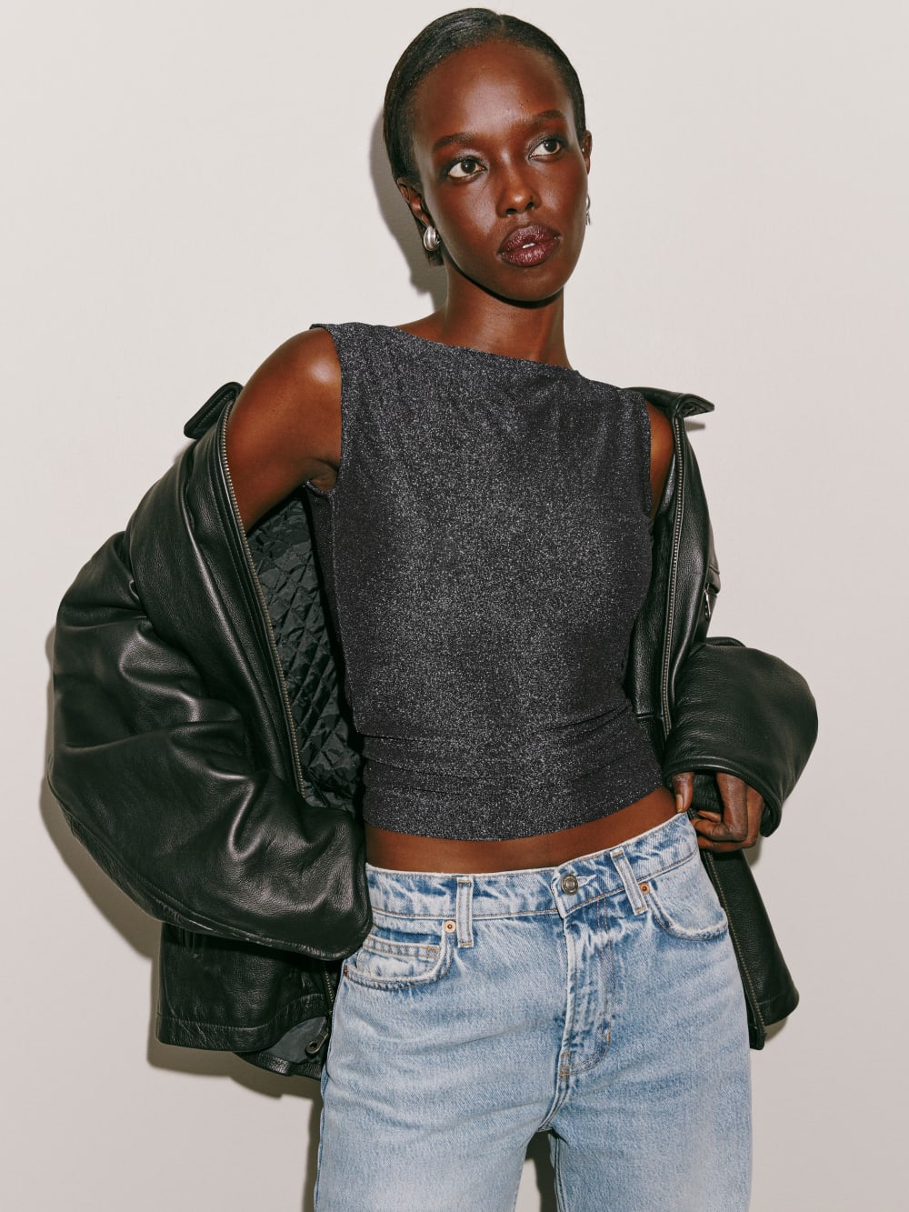 Reformation silver sparkle duke knit top has a straight neck and wide sleeves. 