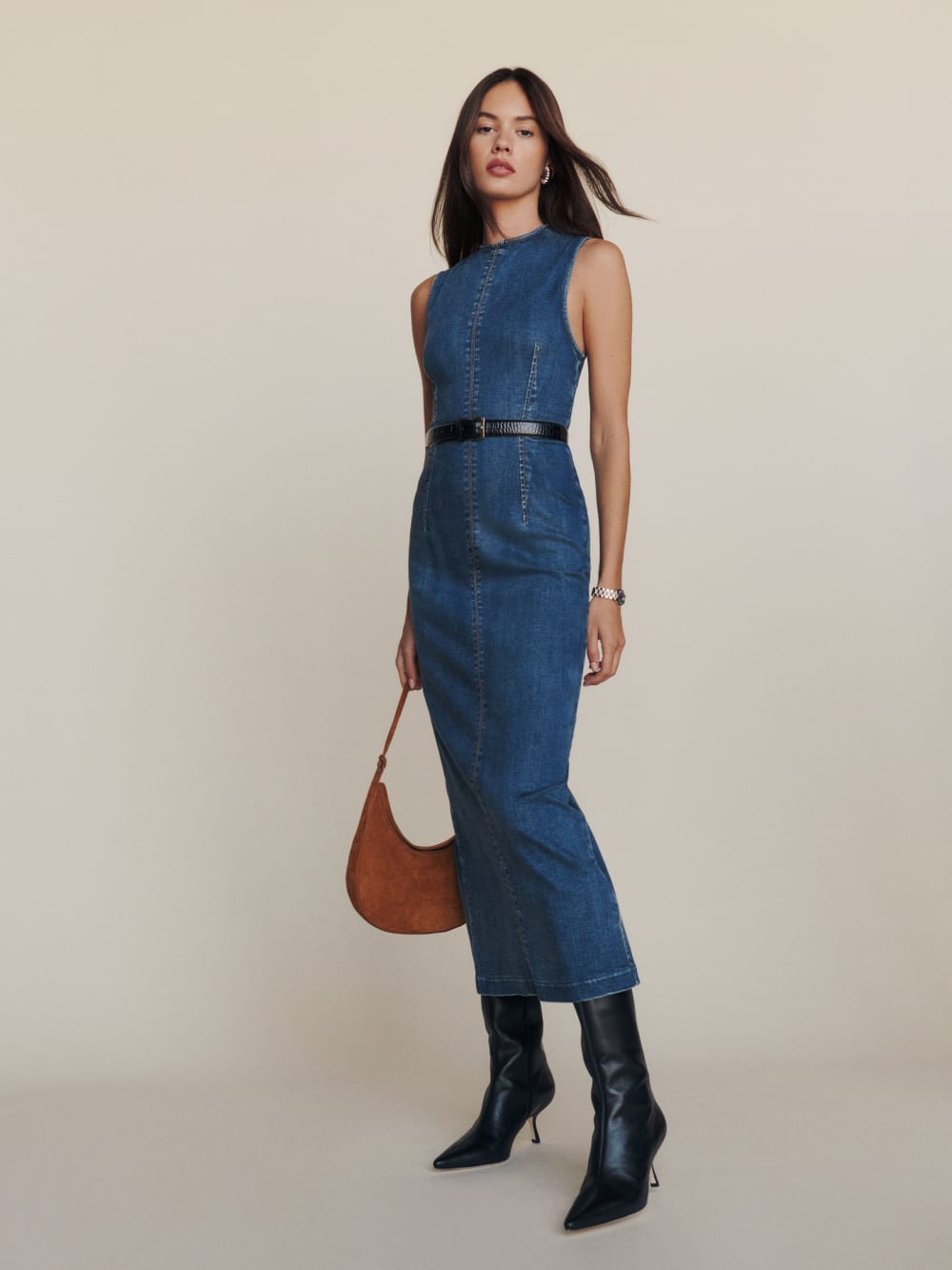 Reformation The Kendi Denim Midi Dress  is a slim fitting midi dress with wide straps, crew neck and back zipper. 