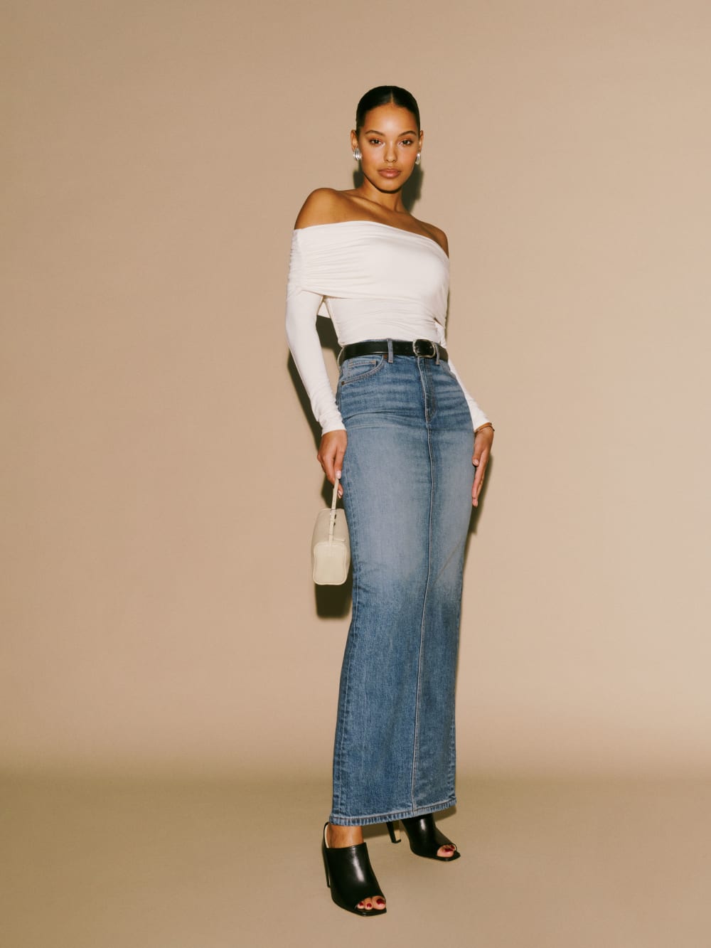 Reformation Daria high rise blue denim maxi skirt with 5 pockets, belt loops, button and zip fly. Fitted with a back slit. 