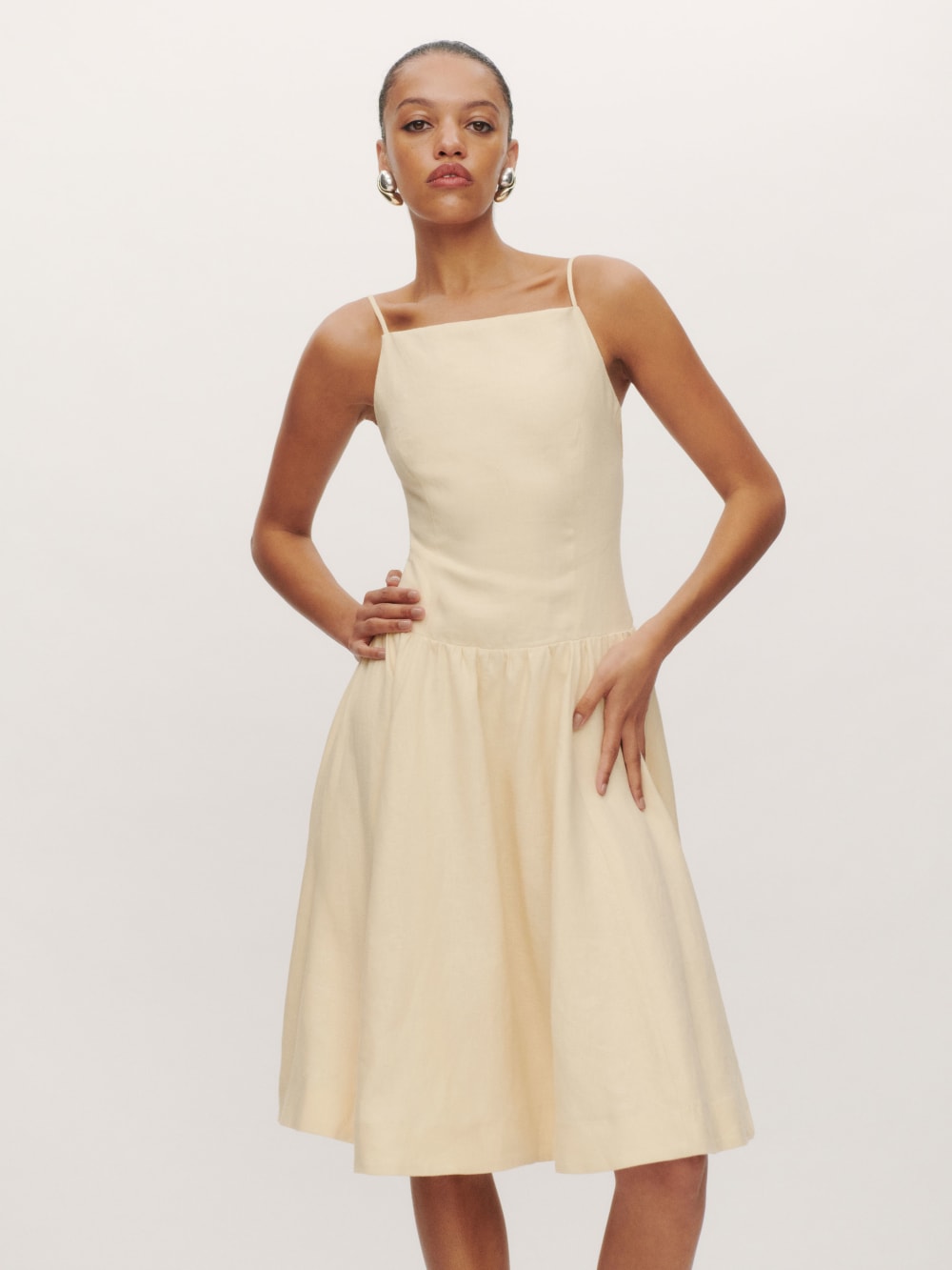2024 wedding guest outfits - Reformation linen butter yellow Clarabelle Linen Dress. Designed to be fitted at bodice with a full skirt, square neck and thin straps. 