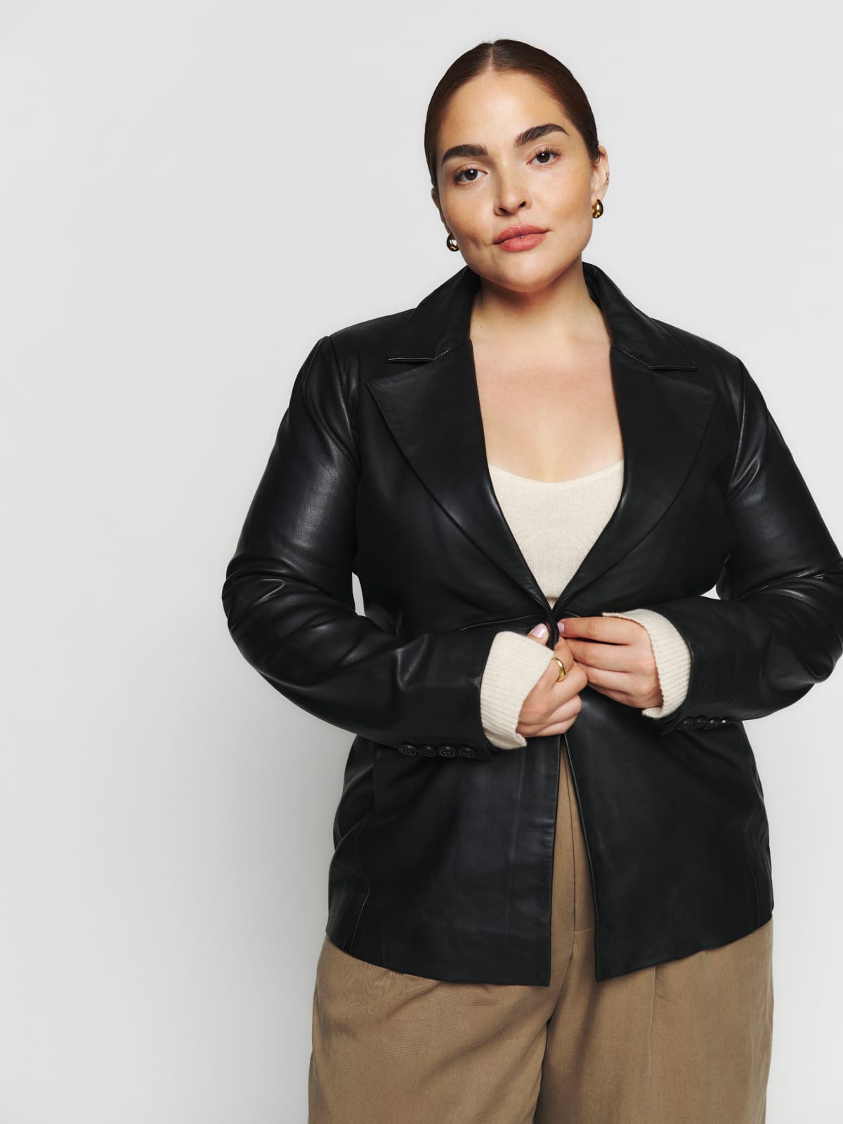 It's jacket season. The Veda black leather blazer is a single breasted, leather blazer with a notched lapel and a center front button. It is slim fitting and hits below the hip.