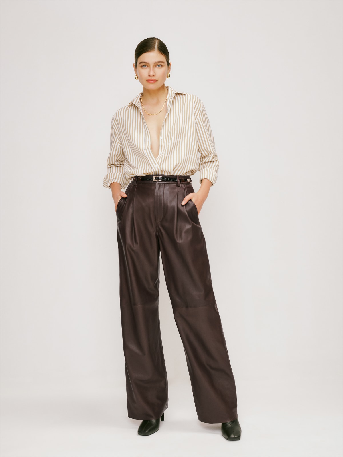 reformation chocolate brown high waisted loose leg leather pant. They have a button and zip fly with belt loops and side pockets. They are fully lined. 