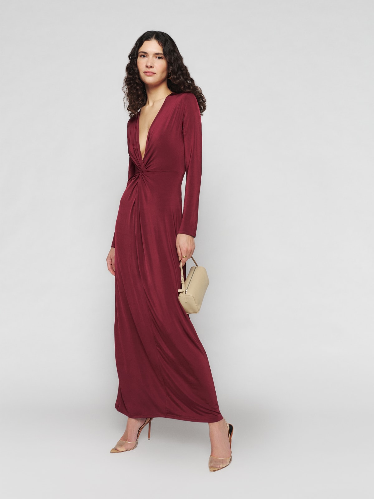 Reformation Elverson maxi dress is a long sleeve, maxi length, fitted dress with a deep V-neck with knot detailing at the waist. It comes in a chianti colour and is made from  Naia™ Renew, a sustainable silk alternative made with renewable wood pulp and repurposed waste. It skims the body and would look amazing for an autumn wedding.