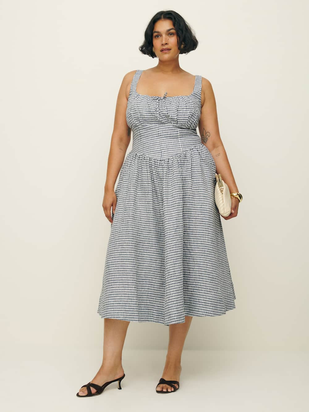 A plus-size, black-and-white gingham midi dress