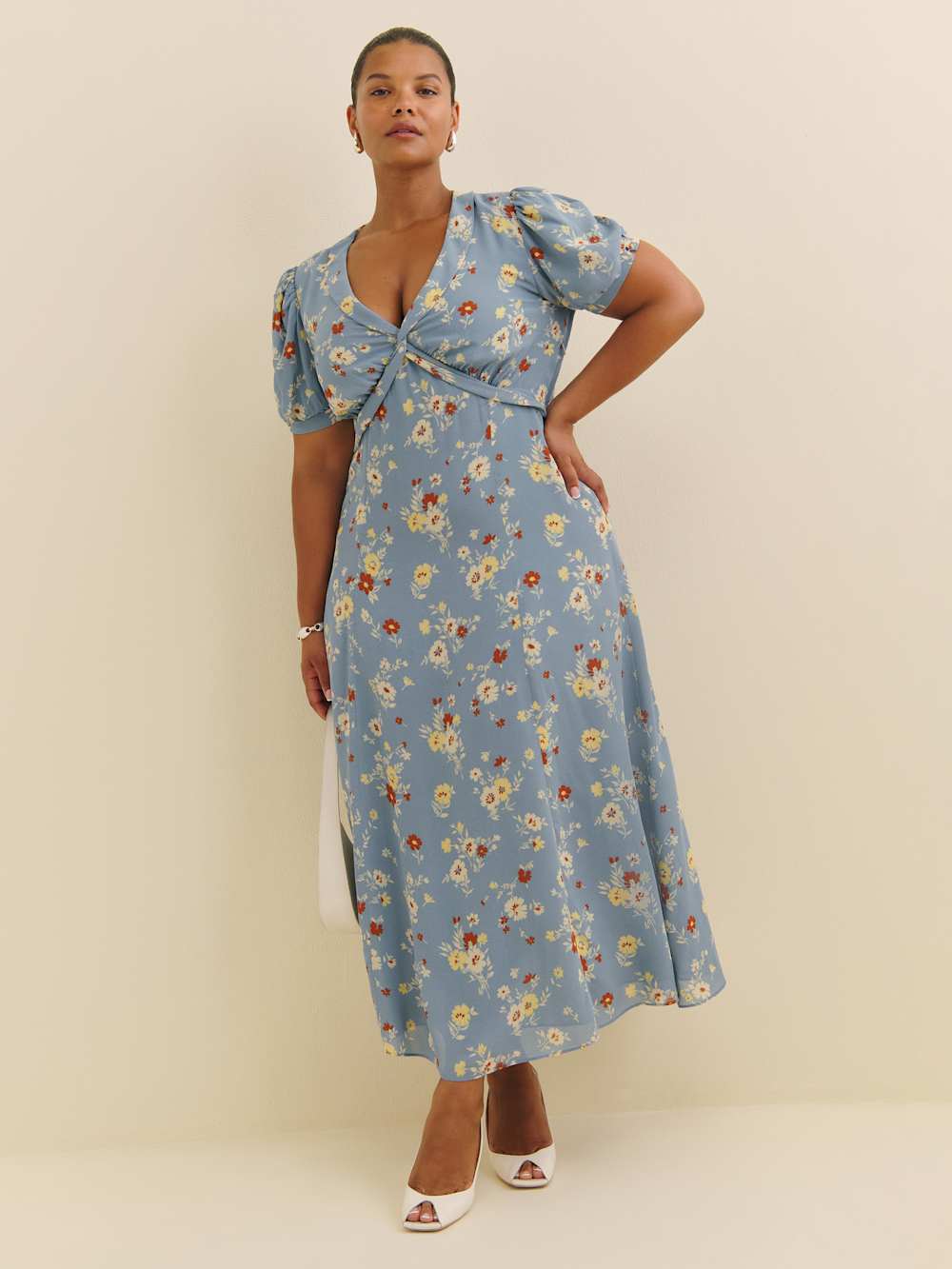 A plus-size, light-blue, puff-sleeve midi dress with red and yellow flowers
