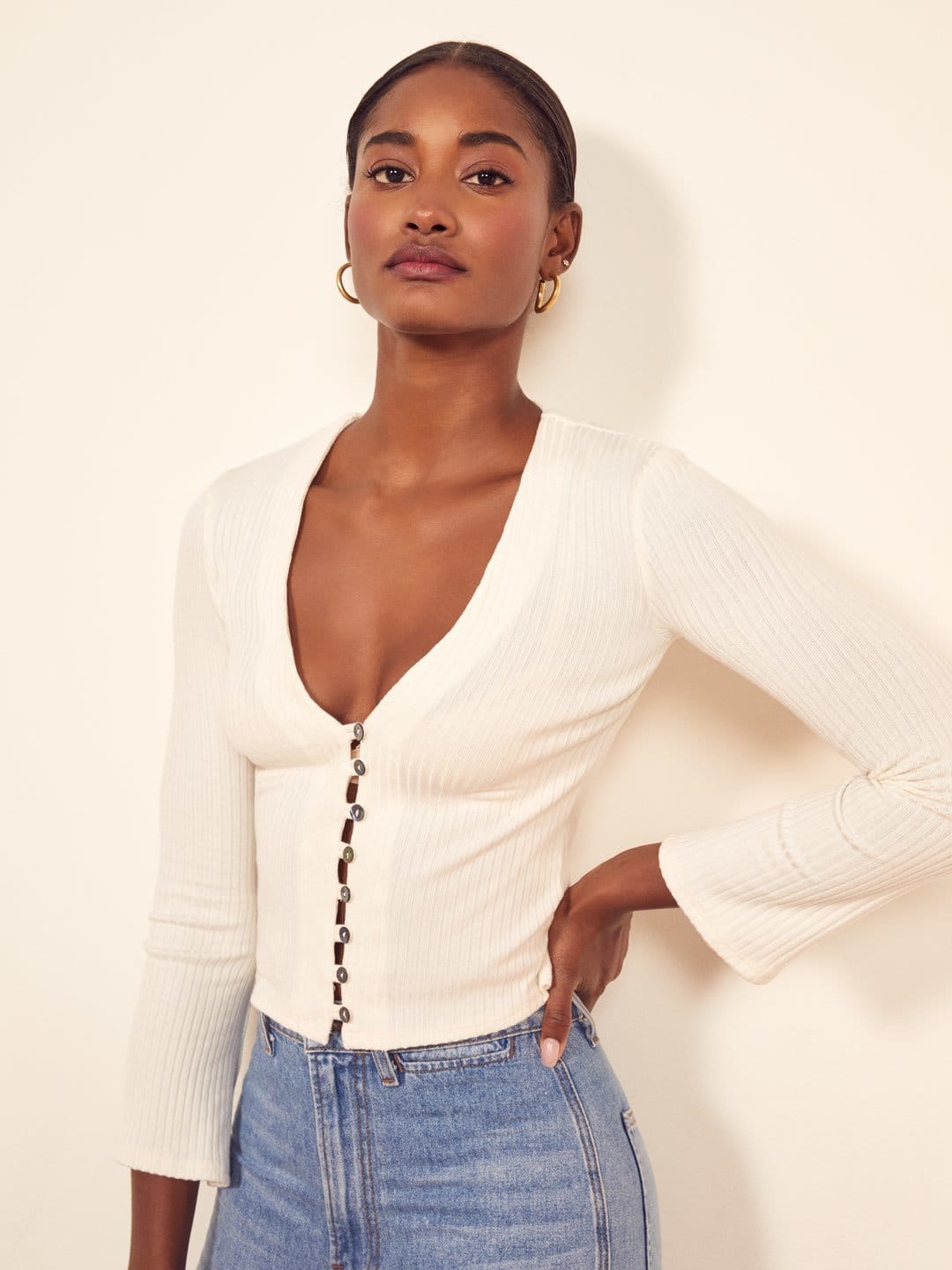 a mini length dress with a v neckline, cap sleeves and a center front tie