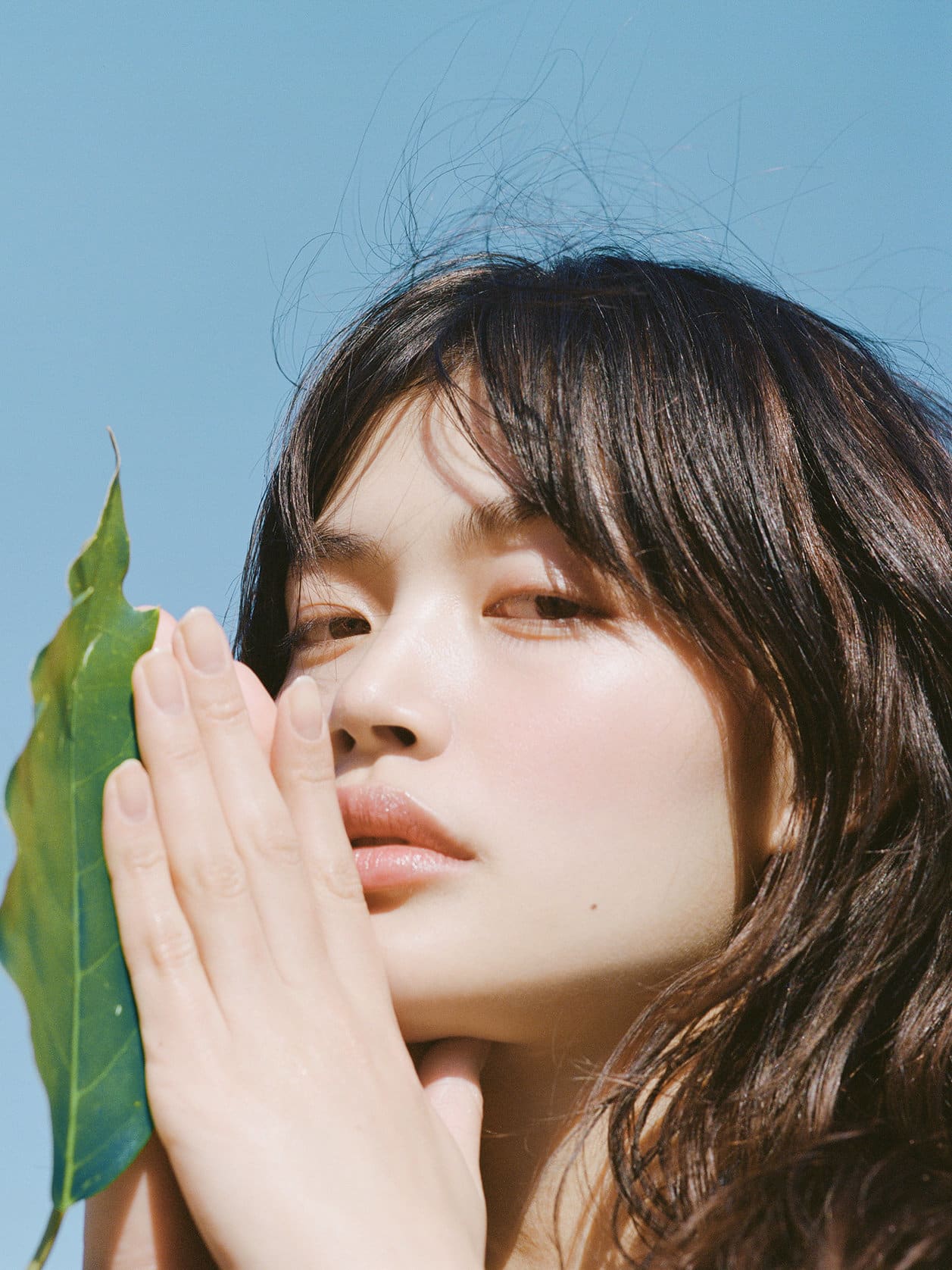 Woman smelling a white flower