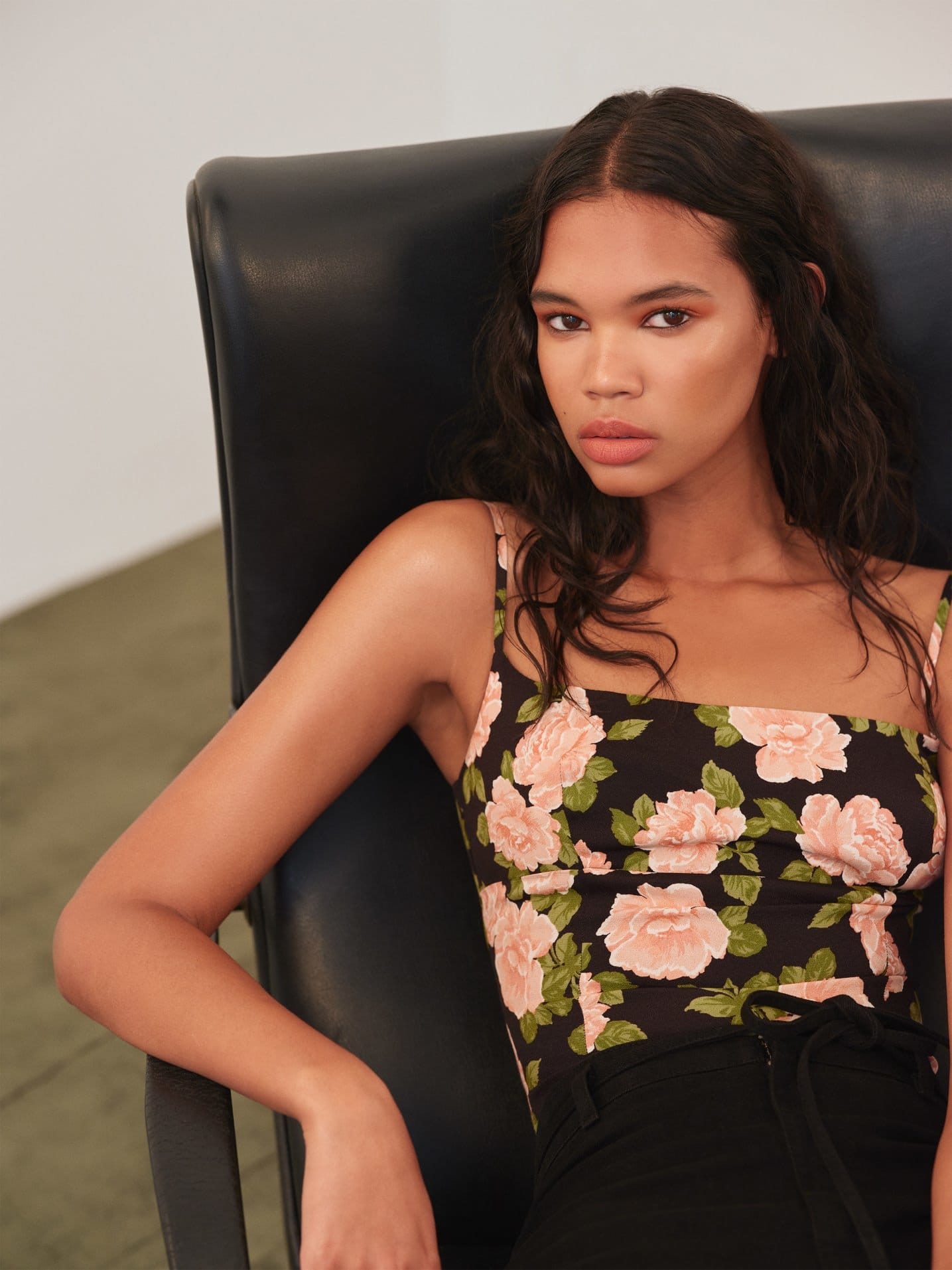 hip length top with a straight neckline, a smocked back bodice and adjustable spaghetti straps.