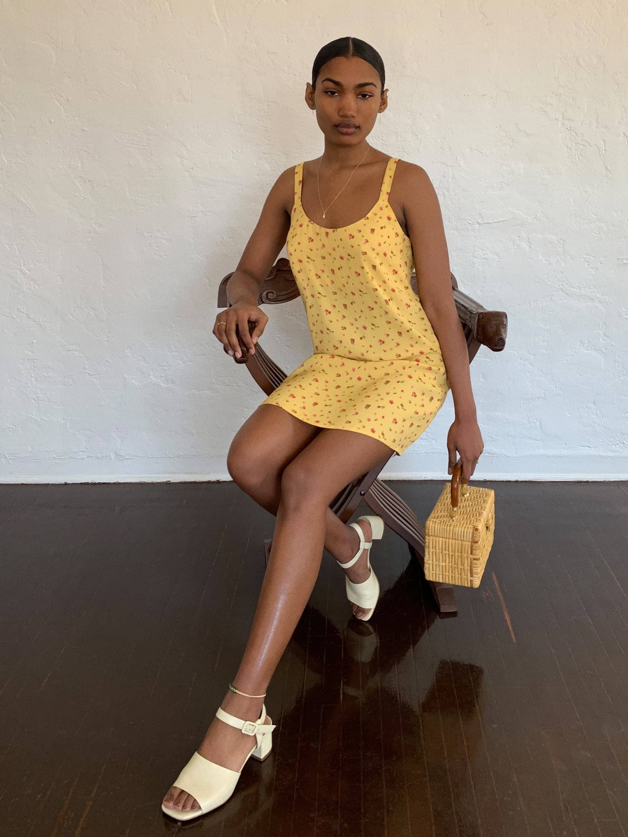 mini length dress with a scoop neckline and thin straps.